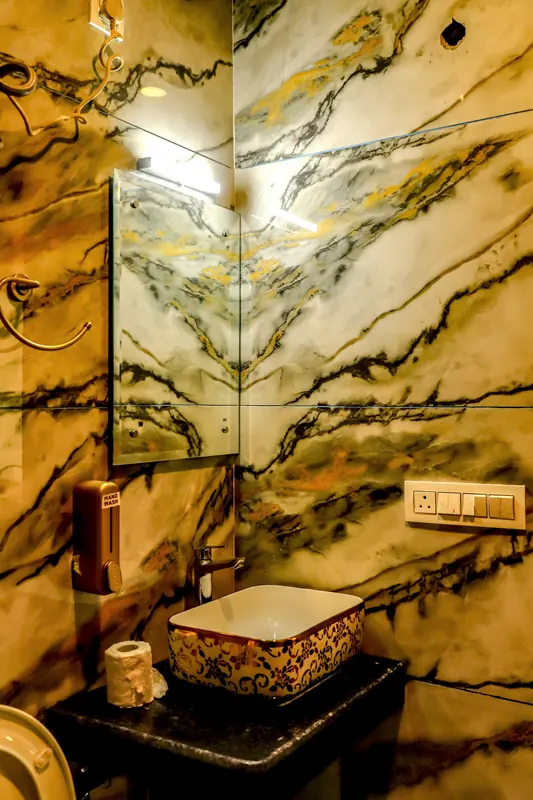 Marble-clad bathroom with countertop basin