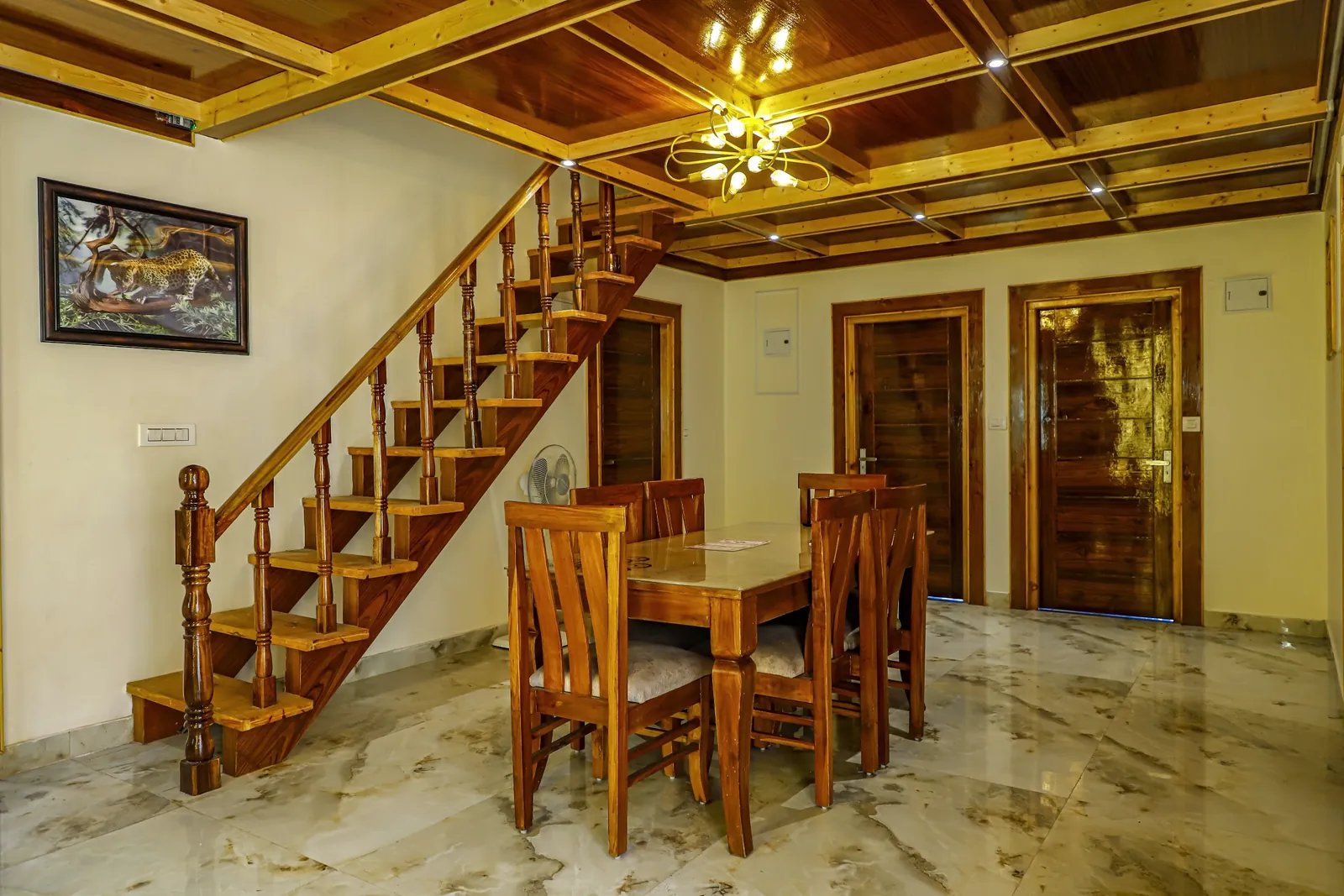 The dining hall at Wood Crista with wooden staircase and coffered ceiling