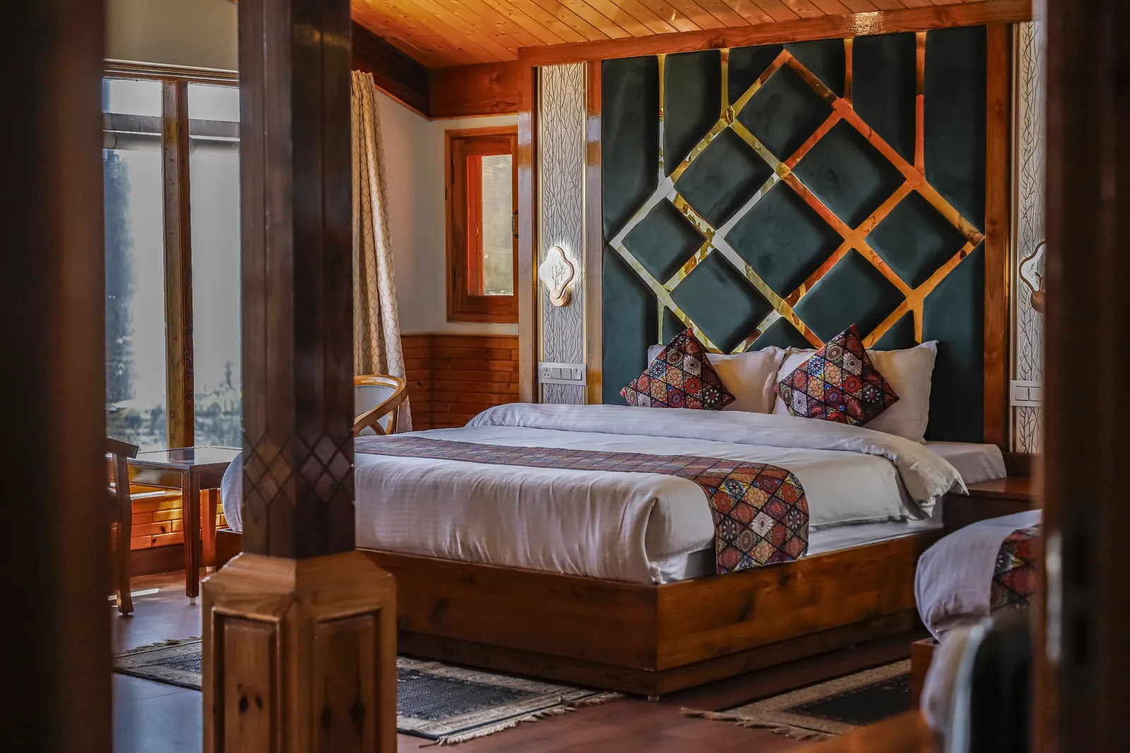 Orchard Suite bed with a teal and brass lattice headboard