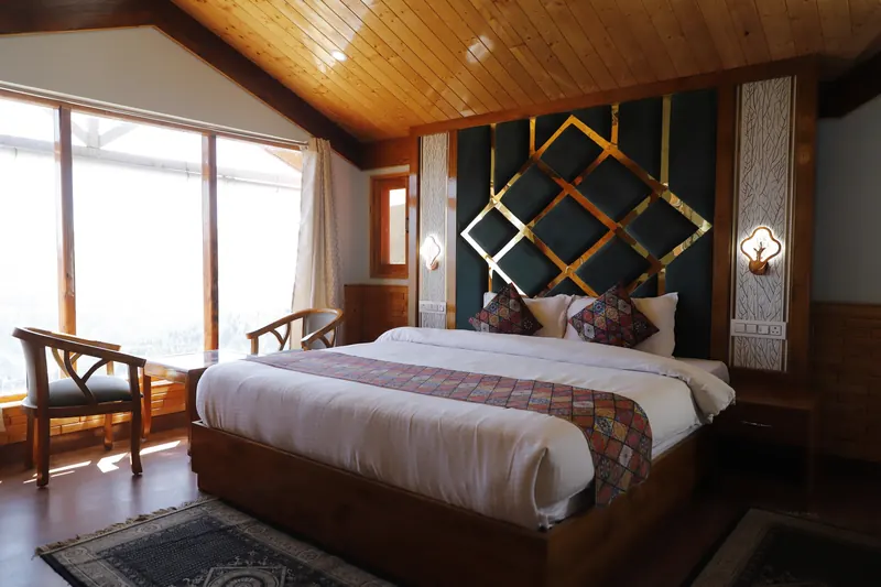 Orchard Suite: bed beside the window