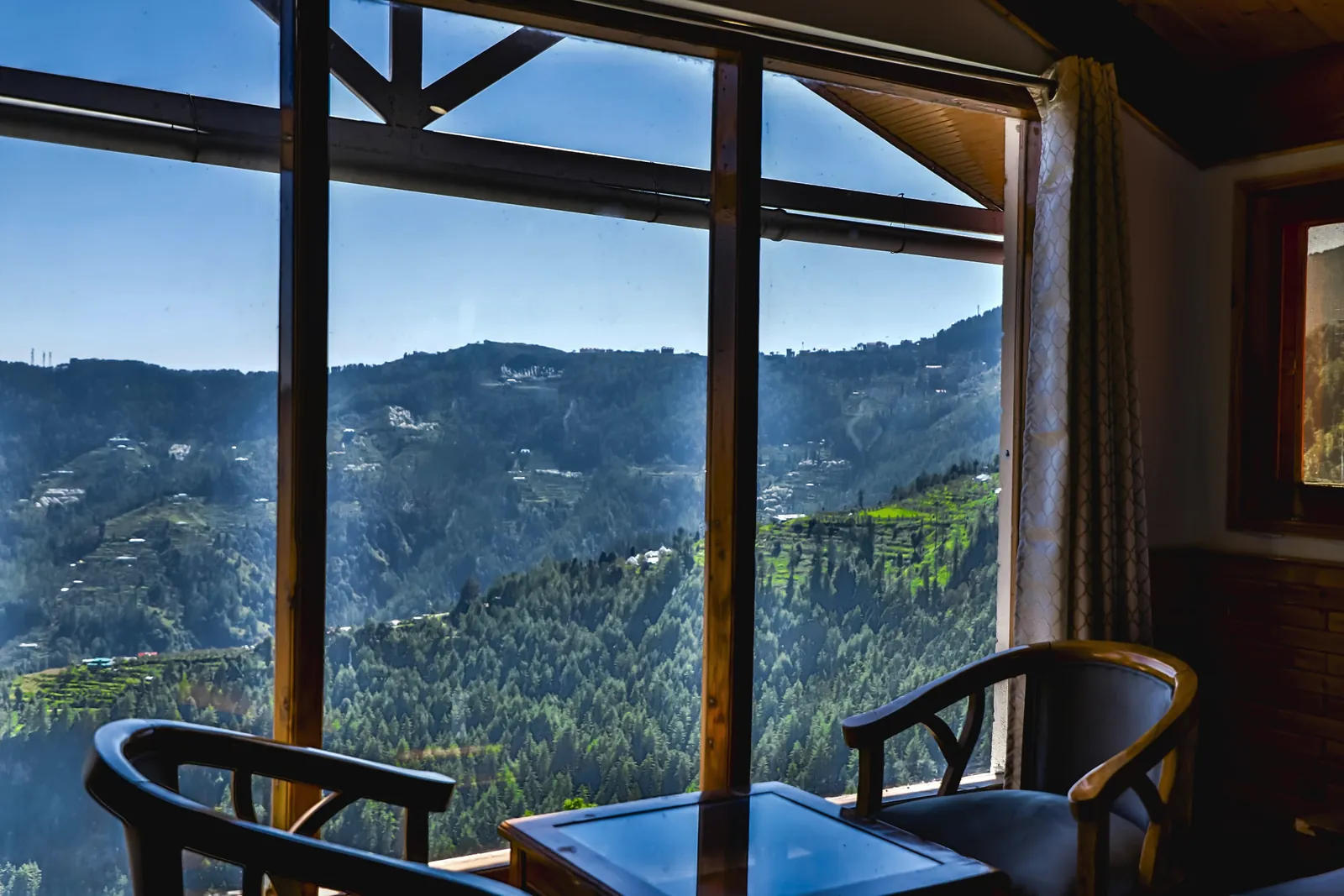 Two chairs at a picture window above the valley